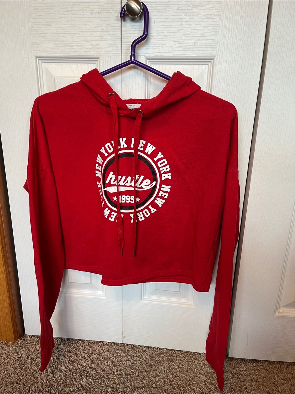 Ardene Women’s bright red hooded sweater with a graphic logo